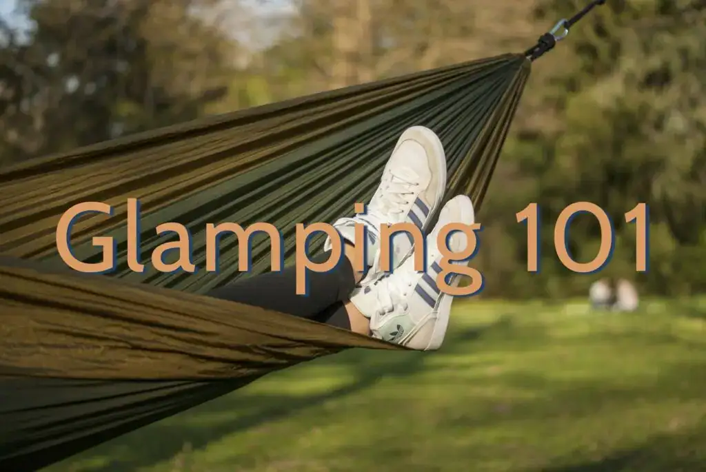 Text that reads "Glamping 101" overlayed on image of woman's legs sticking out of a green hammock.