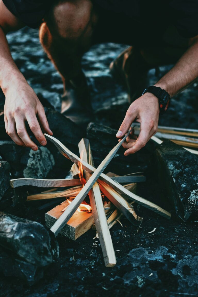 A camper demonstrates how to build a campfire.