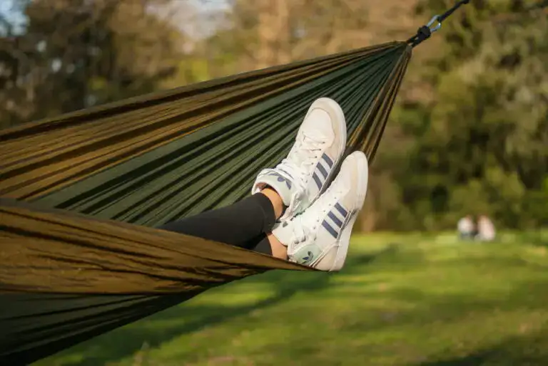 Sneakers protrude from a green hammock.